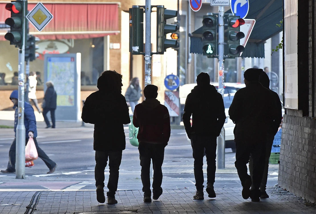 Migrants walk in the so-called “Mahgreb Quarter” in Duesseldorf, Germany. (AP)
