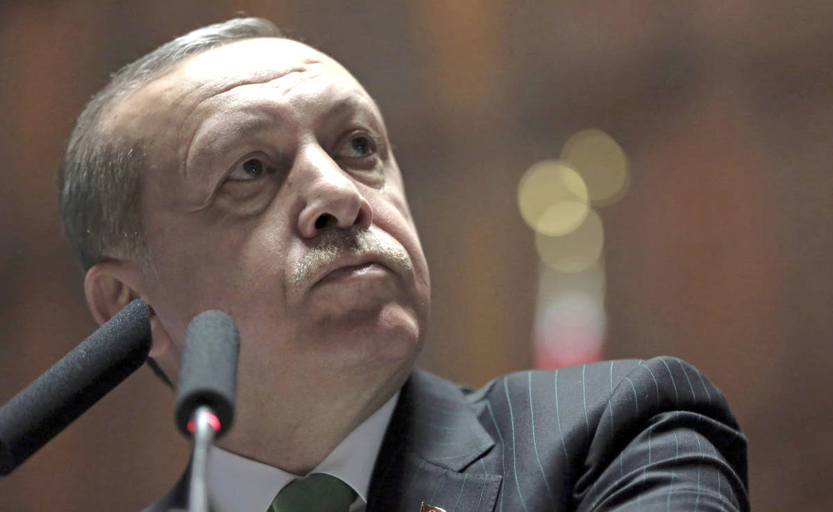 Turkey’s President Recep Tayyip Erdogan listens to cheering supporters as he addresses his lawmakers at the parliament in Ankara, Turkey, Tuesday, Jan. 16, 2018. (AP)