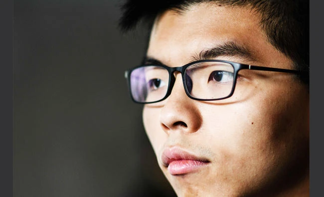 Pro-democracy activist Joshua Wong prepares to enter the High Court to hear his sentence on a protest related charge in Hong Kong on Wednesday. (AFP)