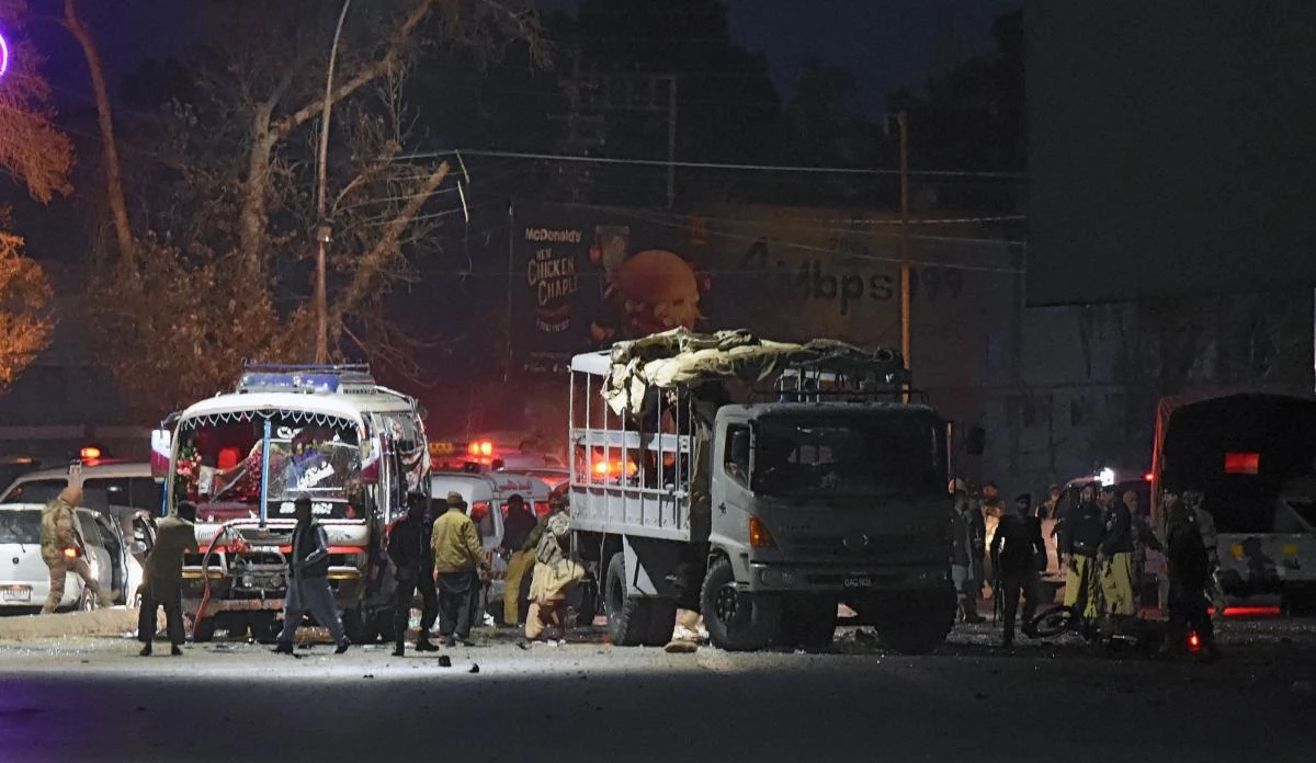 Pakistani security officials gather around a damaged police bus at the site of suicide bomb attack in Quetta on January 9, 2018. (AFP)
