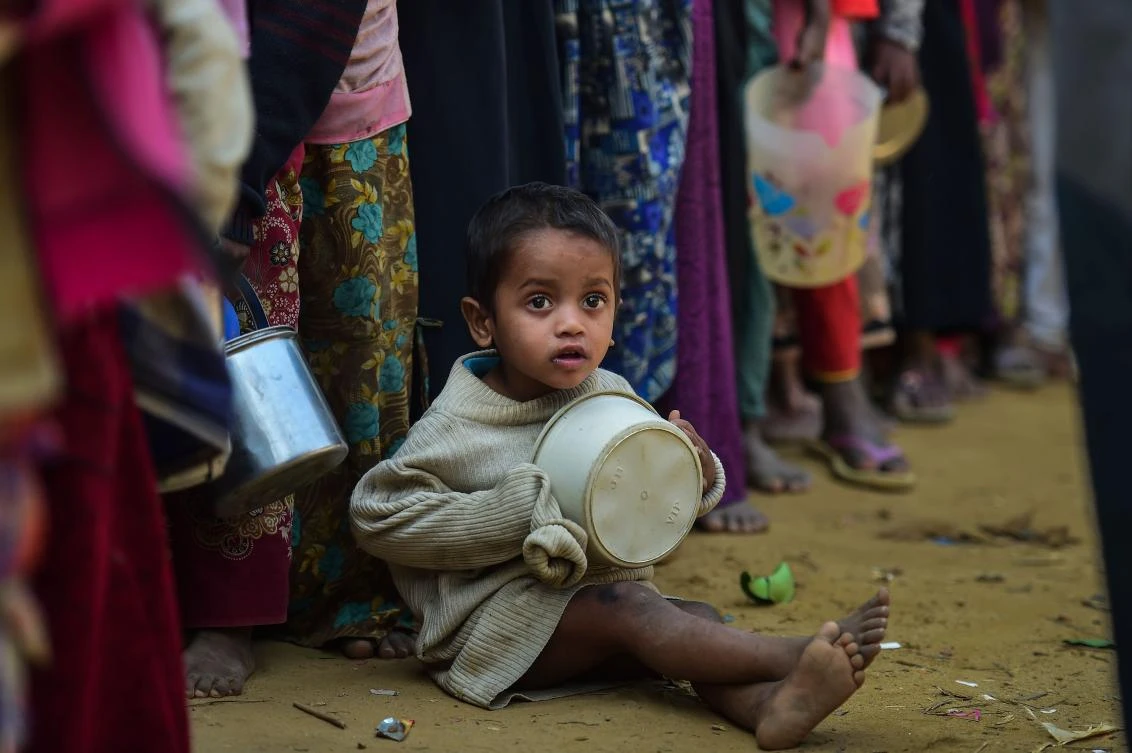 A Rohingya refugee waits with others for food aid at Thankhali refugee camp in Bangladesh's Ukhia. Some of the refugees have been living in Bangladesh for many years, but the repatriation agreement only covers those who have arrived since October 2016. (AFP)