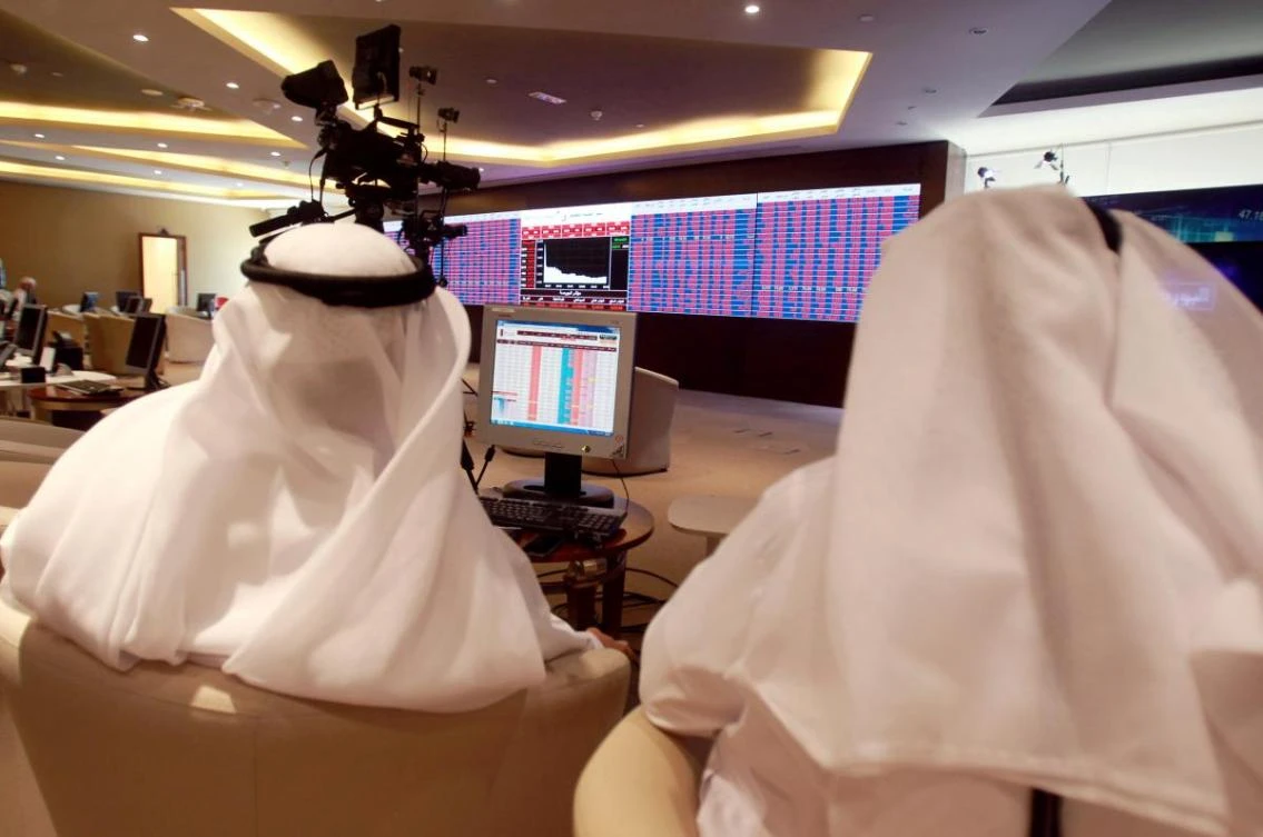 Traders monitor screens displaying stock information at Qatar Stock Exchange in Doha. (Reuters)
