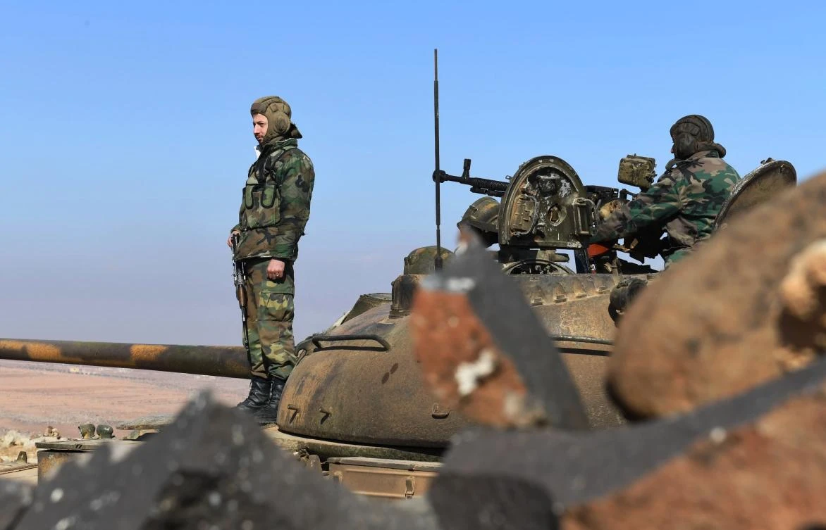 Above, Syrian government forces stand on a tank in Jabal Al-Hass in the southern part of Aleppo province as they advance towards the Abu Duhur military airport in the ongoing offensive against opposition fighters. (AFP)