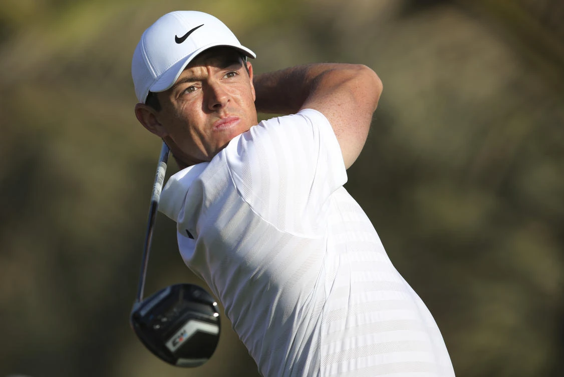 Northern Ireland's Rory McIlroy tees off on the 14th hole during the first round of the Abu Dhabi Championship golf tournament in the UAE. (AP)