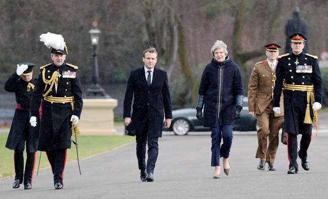 Britain's Prime Minister Theresa May and French President Emmanuel Macron visit the Royal Military Academy Sandhurst, near Camberley, England, Thursday, ahead of the UK-France summit talks. (AP)