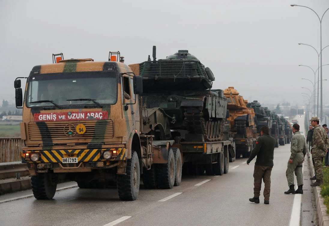 Above, a Turkish military convoy arrives at an army base in the border town of Reyhanli near the Turkish-Syrian border. (Reuters)