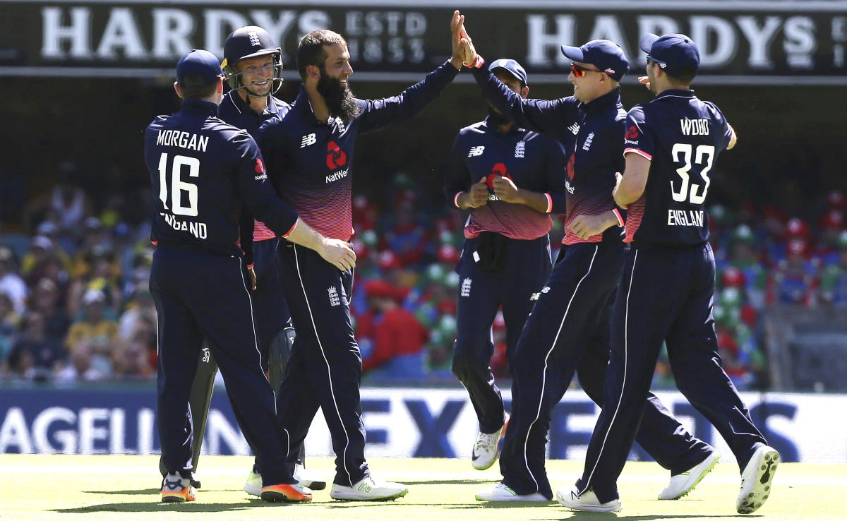 England’s Moeen Ali, center without a cap, celebrates with his team after he got the wicket of Australia’s David Warner, not shown, during the one-day cricket match between England and Australia in Brisbane, Friday, Jan. 19, 2018. (AP)