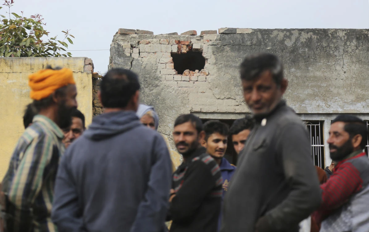 Indian villagers gather a near house damaged allegedly due to firing from the Pakistan side of the border, near Pindi in Arnia district of Jammu and Kashmir, India, Thursday, Jan.18,2018. Indian officials say a teenage girl and a soldier have been killed by Pakistani troops firing along the volatile frontier in Indian-controlled Kashmir. (AP)