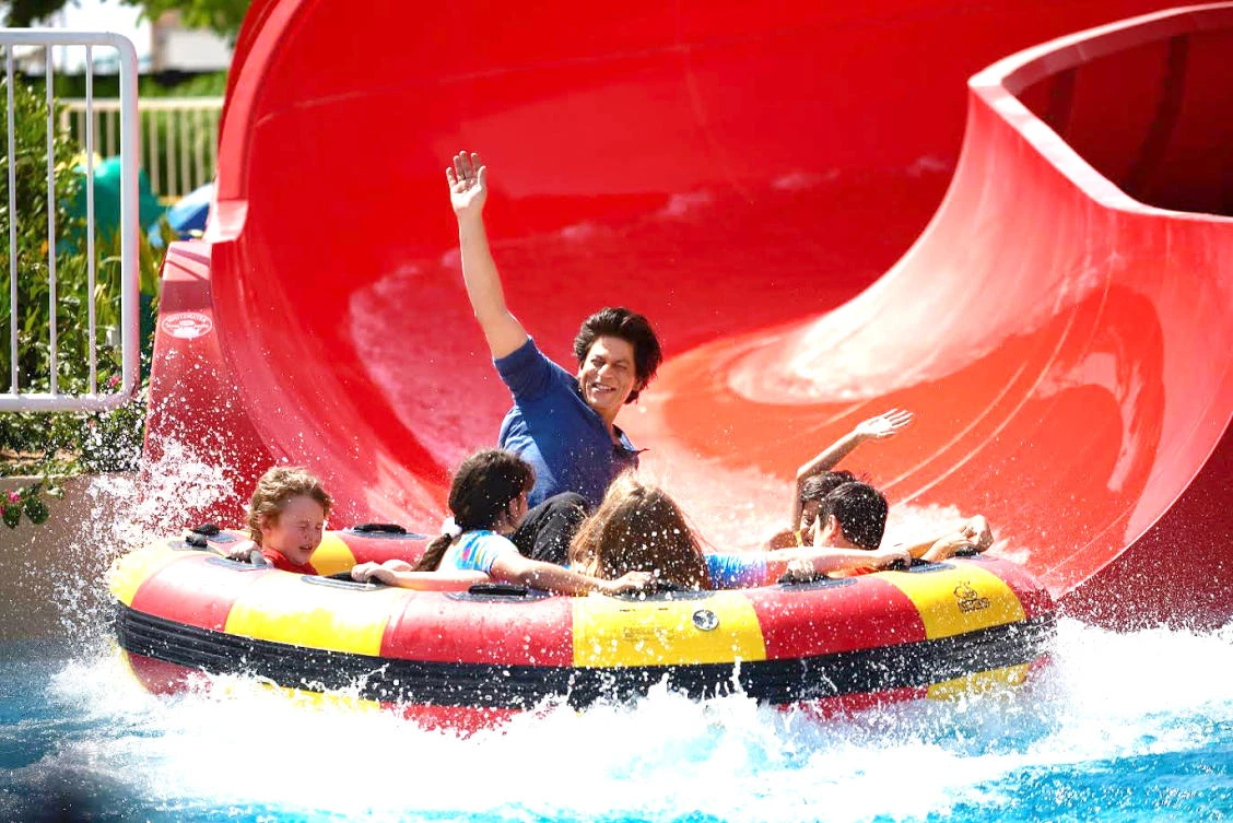 Bollywood star Shah Rukh Khan enjoys a water slide during the launch of the #BeMyGuest campaign in Dubai.