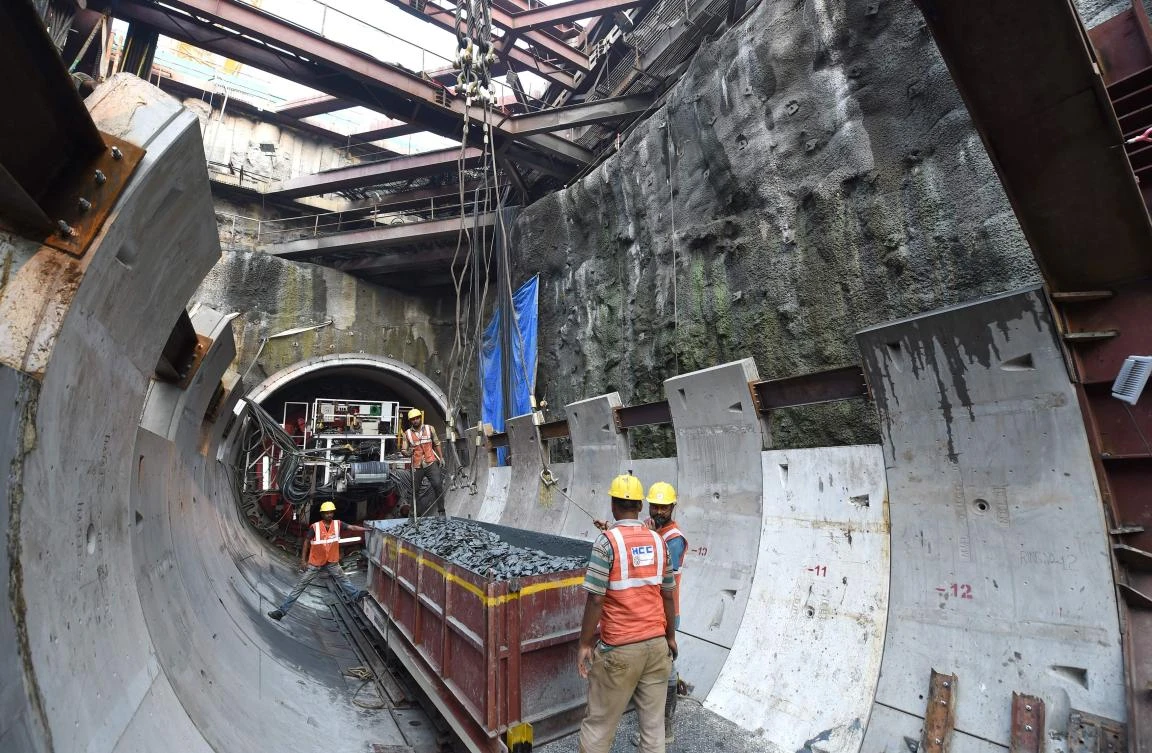 This picture taken on December 11, 2017 shows workers preparing to lift up a load of rocks at a metro railway working site in Mumbai. (AFP)