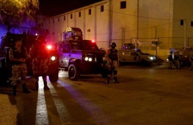 Security forces stand guard outside the Israeli embassy in the residential Rabiyeh neighbourhood of the Jordanian capital Amman following an 'incident'. (AFP)