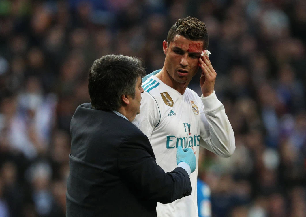 Cristiano Ronaldo receives treatment after sustaining an injury whilst scoring Real's sixth goal. (Reuters)