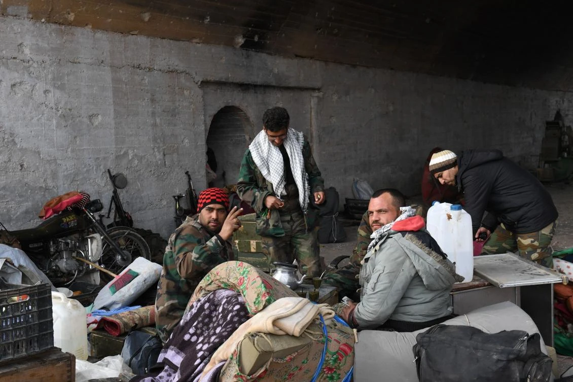 Syrian government forces gather at the Abu Duhur military airport area in Idlib province, on January 21, 2018. (AFP)