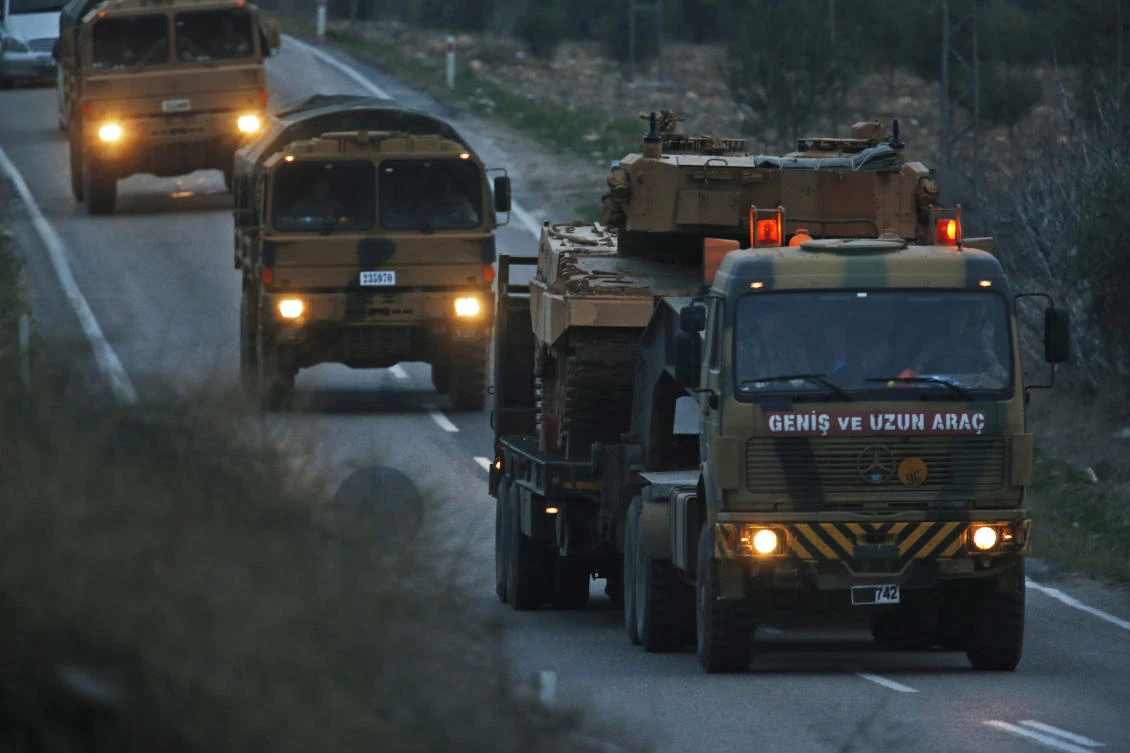 Trucks, one transporting a Turkish Army tank, form a convoy on the outskirts of Kilis, Turkey, near the border with Syria. Turkey’s ground troops entered the enclave of Afrin in northern Syria and were advancing with Turkish-backed Syrian opposition forces in their bid to oust US-allied Syrian Kurdish forces from the region. (AP)