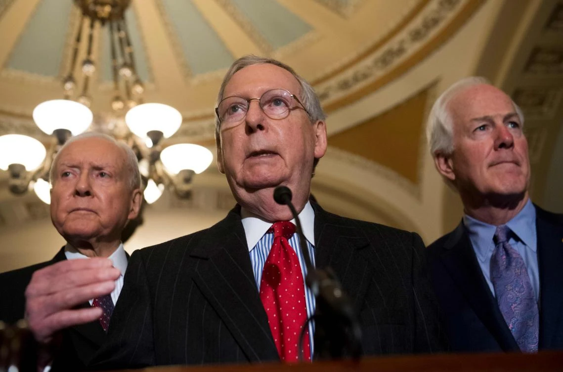 US Senate Majority Leader Mitch McConnell (C), alongside US Senate Majority Whip John Cornyn (R), Republican of Texas, and US Senator Orrin Hatch (L), Republican of Utah. (AFP)