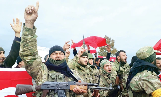 Free Syrian Army fighters shout slogans before heading toward the Syrian border, in Kirikhan, Turkey. (AP)