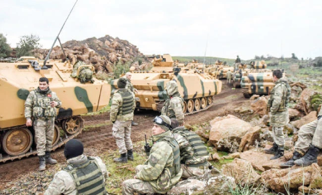 Turkish troops gather near the Syrian border at Hassa, in Hatay province on Sunday. (AFP)