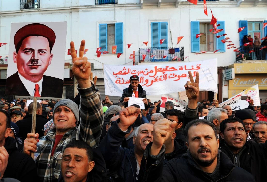 Tunisian workers shout slogans against the government in front of the Tunisian General Labour Union (UGTT) headquarters in Tunis. (File Photo: AFP)