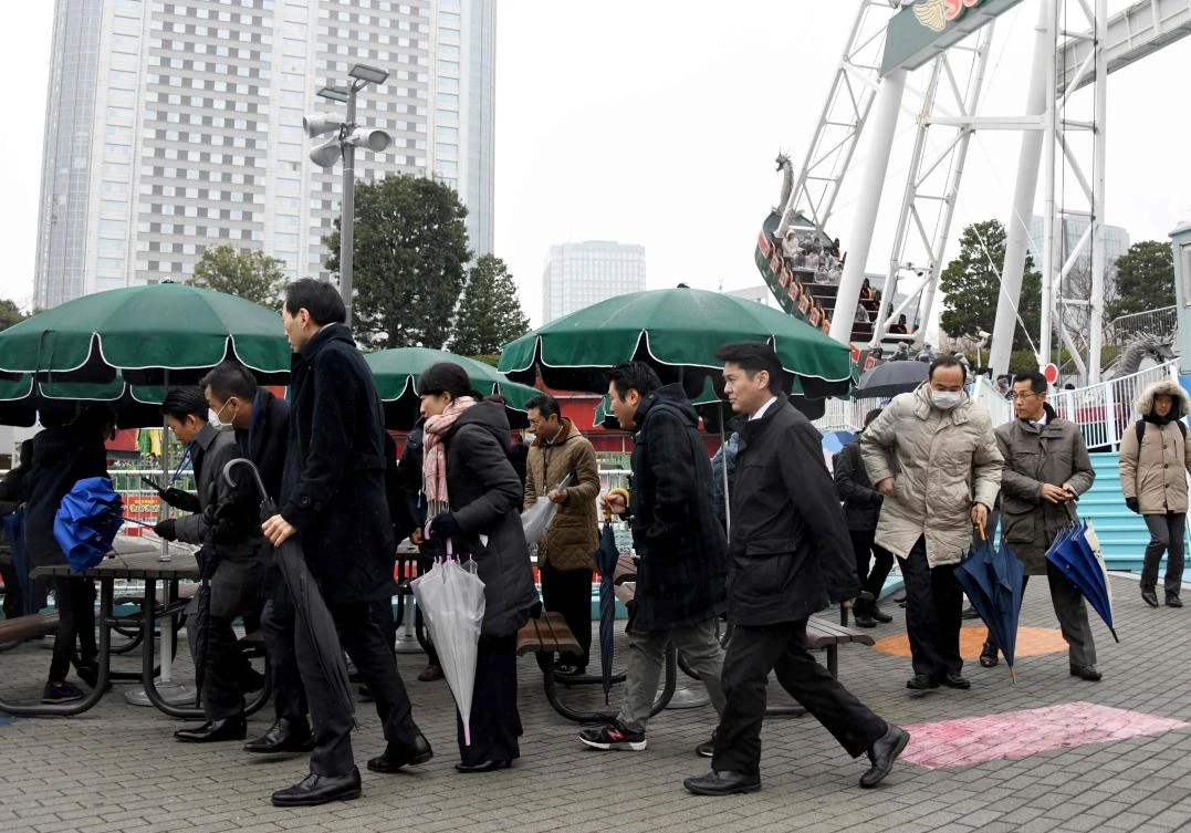 Amusement park visitors participate in an evacuation drill in Tokyo on January 22. Every time North Korea launches a missile over Japan, the nation’s alert system warns residents via mobile phones and streetside loudspeaker broadcasts. (AFP)