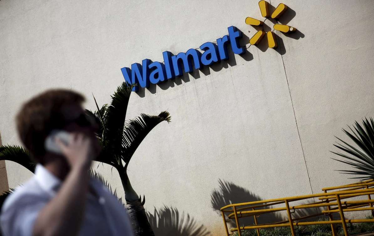 Above, a man talks on his mobile phone in front of a Wal-Mart store in Sao Paulo, Brazil. Wal-Mart’s operations in Brazil had not improved over the last two years, which coincided with the country’s harshest recession in decades. (Reuters)
