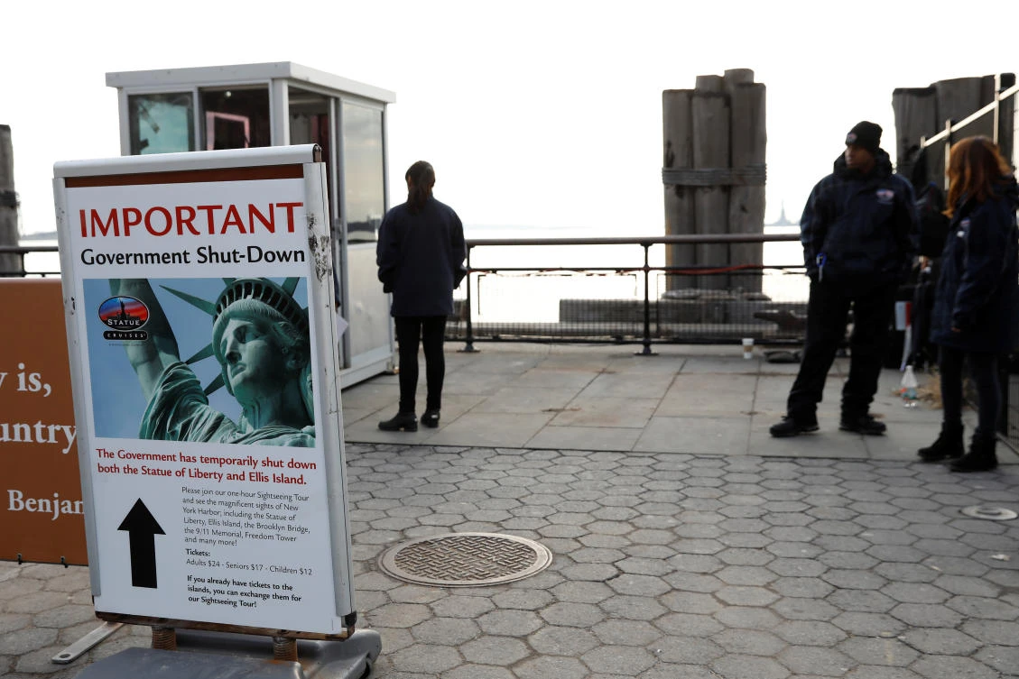 Above, a sign announces the closure of the Statue of Liberty due to the US government shutdown. The US government had not previously been shut down since 2013, when about 800,000 federal workers were put on furlough. (Reuters)