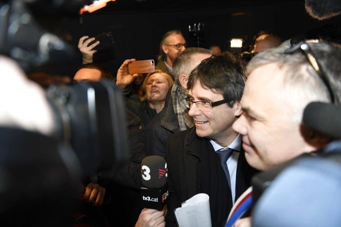 Former Catalan leader Carles Puigdemont answers journalists’ questions upon his arrival at Copenhagen airport on January 22. Spain’s prosecution service has said it would “immediately” have a supreme court judge issue a warrant for his arrest if he traveled to Denmark. (AFP)