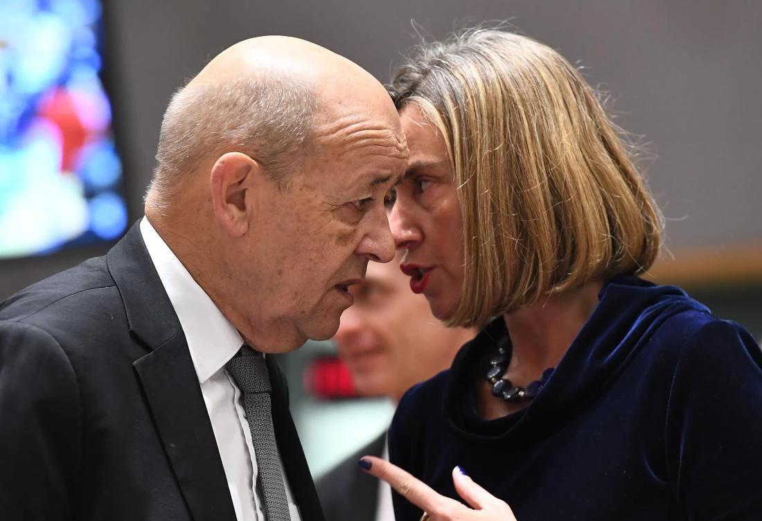 France's Foreign Minister Jean-Yves Le Drian (L) and EU foreign policy chief Federica Mogherini speak together as they arrive for a foreign affair council at the European Council in Brussels, January 22, 2018. (AFP