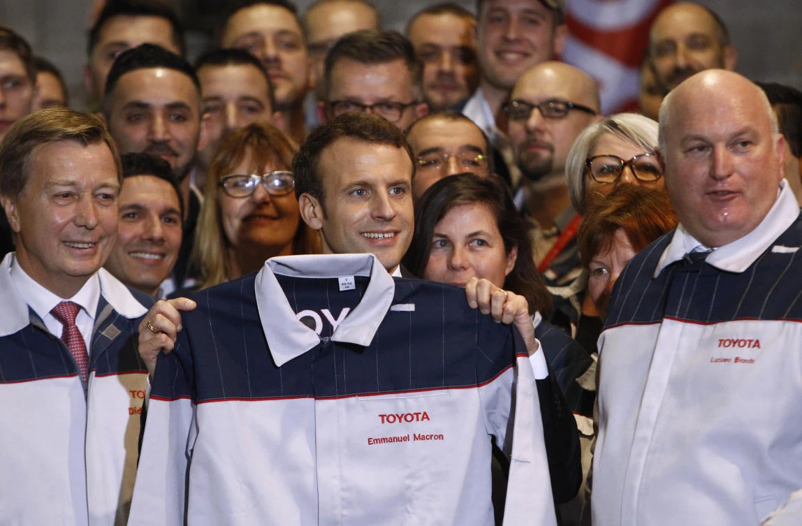 French President Emmanuel Macron visits Toyota’s automobile manufacturing plant with Director Luciano Biondo, right, in Onnaing, northern France, Monday, Jan. 22, 2018. (AP)