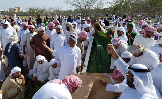 Relatives and friends gather at the Rol Dhadna cemetery in Fujairah on Monday for the funeral of seven siblings who suffocated in a house fire. (Courtesy: Hanaalblooshi via Twitter)