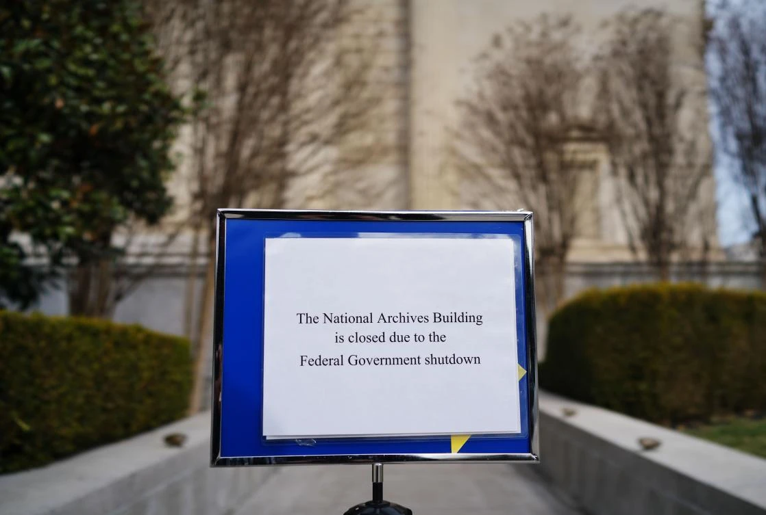Above, a notice alerts visitors that the National Archives building in Washington DC is closed due to a government shutdown. (AFP)