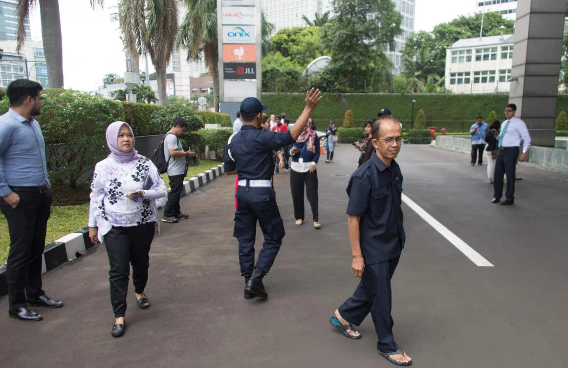 Above, workers stand outside their buildings in Jakarta. According to the US Geological Service, the earthquake was centered offshore western Java at a depth of about 43 kilometers. (AFP)
