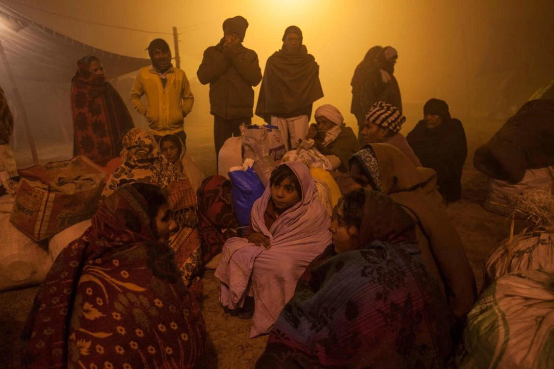 Hindu devotees gathering after arriving at Sangam, the confluence of the rivers Ganges, Yamuna and mythical Saraswati, for a holy dip during Magh Mela festival in Allahabad. (AFP)