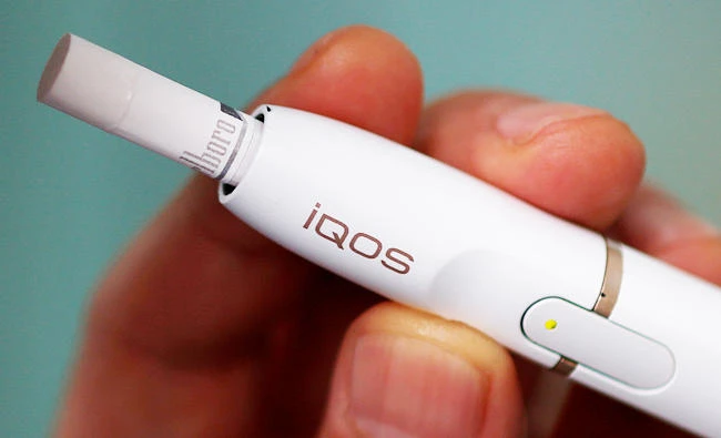A man uses a Philip Morris iQOS e-cigarette in Tokyo, Japan, in this May 12, 2017 file photo. (REUTERS)