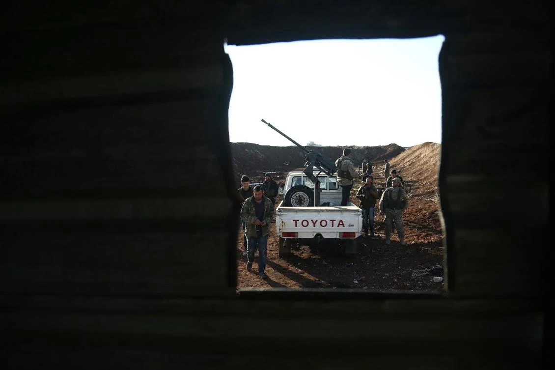 Turkish-backed fighters from the Free Syrian Army hold a position in the Tal Malid area, north of Aleppo, as they prepare to target Kurdish People's Protection Units (YPG) positions in the area of Afrin, on January 20, 2018. (AFP)