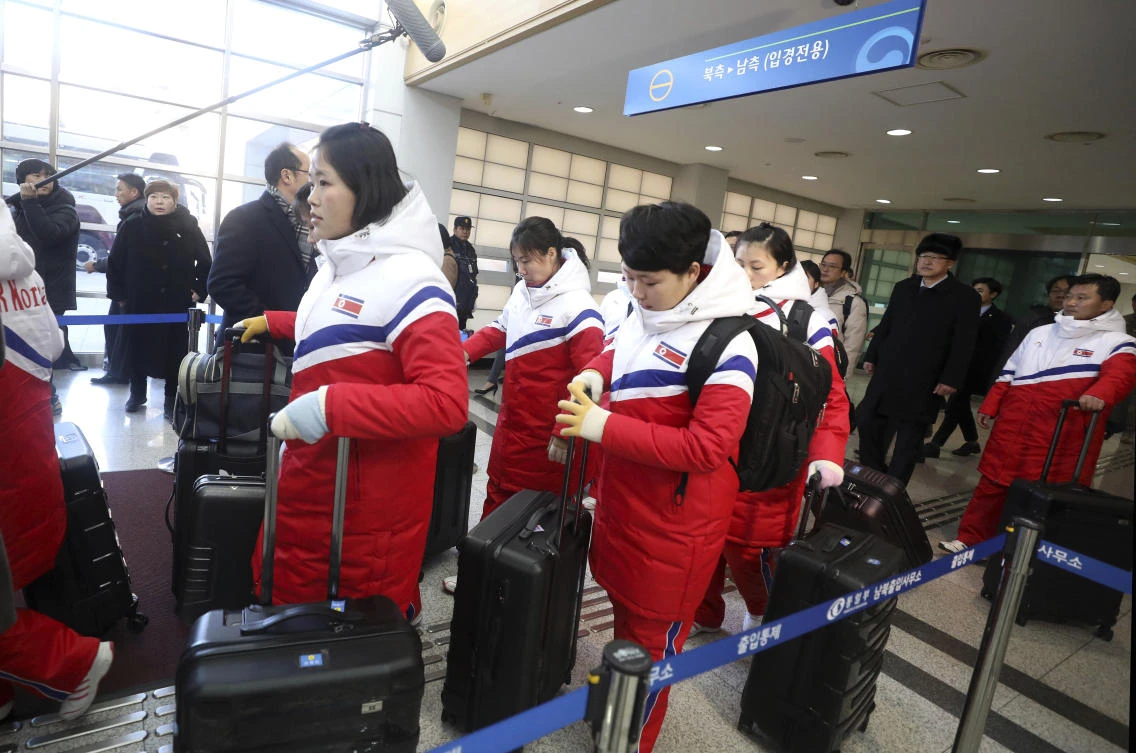 North Korean women hockey players arrive at the Inter-Korean Transit Office in Paju, South Korea. The North Korean hockey players were heading to a southern South Korea training center, where they will be united with their 23 South Korean teammates. (Korea Pool Photo via AP)