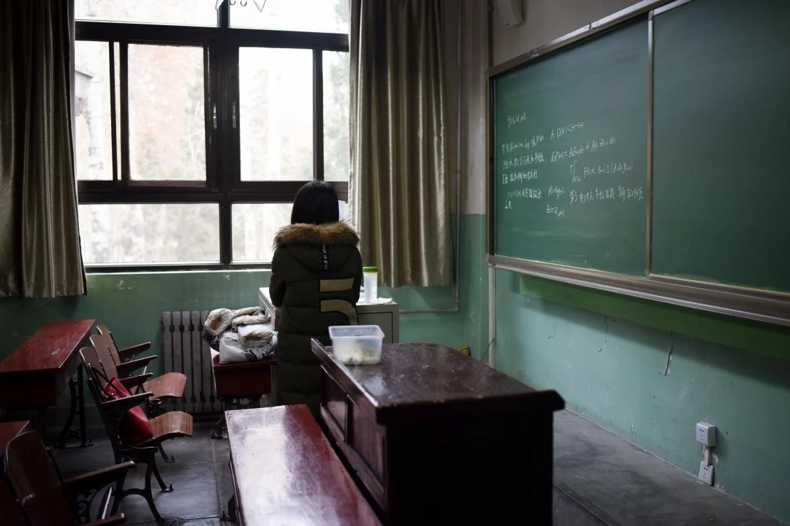 This picture taken on January 17, 2018 shows a female student in a classroom at Beihang University in Beijing. Beijing’s Beihang University recently stripped a professor of his position as vice-director of the graduate school after an investigation established he had sexually harassed multiple students. The hashtags “Me too” and “Me too in China” quickly became trending topics on Weibo, with many more people speaking about their assaults in the forums. — TO GO WITH China-education-harassment-assault,FOCUS by Joanna CHIU / AFP / WANG ZHAO / TO GO WITH China-education-harassment-assault,FOCUS by Joanna CHIU