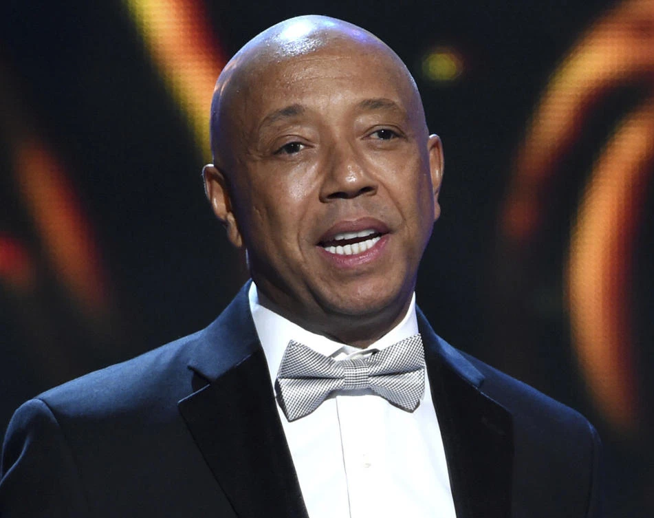 Hip-hop mogul Russell Simmons presents the Vanguard Award on stage at the 46th NAACP Image Awards in Pasadena, California A Los Angeles woman is suing Simmons, alleging he raped her at his home in 2016. An attorney for 37-year-old Jennifer Jarosik filed the lawsuit Wednesday, Jan. 24, 2018. (Chris Pizzello/Invision/AP, File)