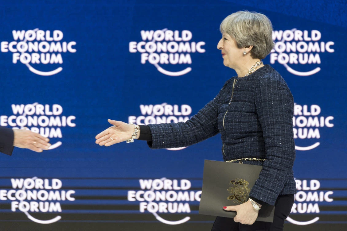 British Prime Minister Theresa May, is welcomed to a session of the World Economic Forum in Davos. (AP)