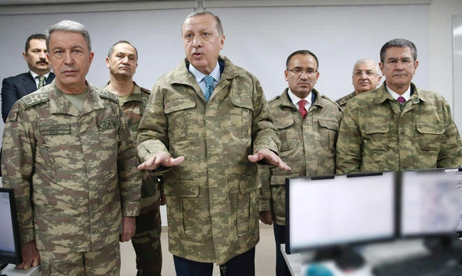 President of Turkey Recep Tayyip Erdogan (2L) speaking as he is flanked by Chief of the General Staff of the Turkish Armed Forces Hulusi Akar (L) during his visit to Operating Base in Hatay on the sixth day of 'Operation Olive Branch'. (AFP)