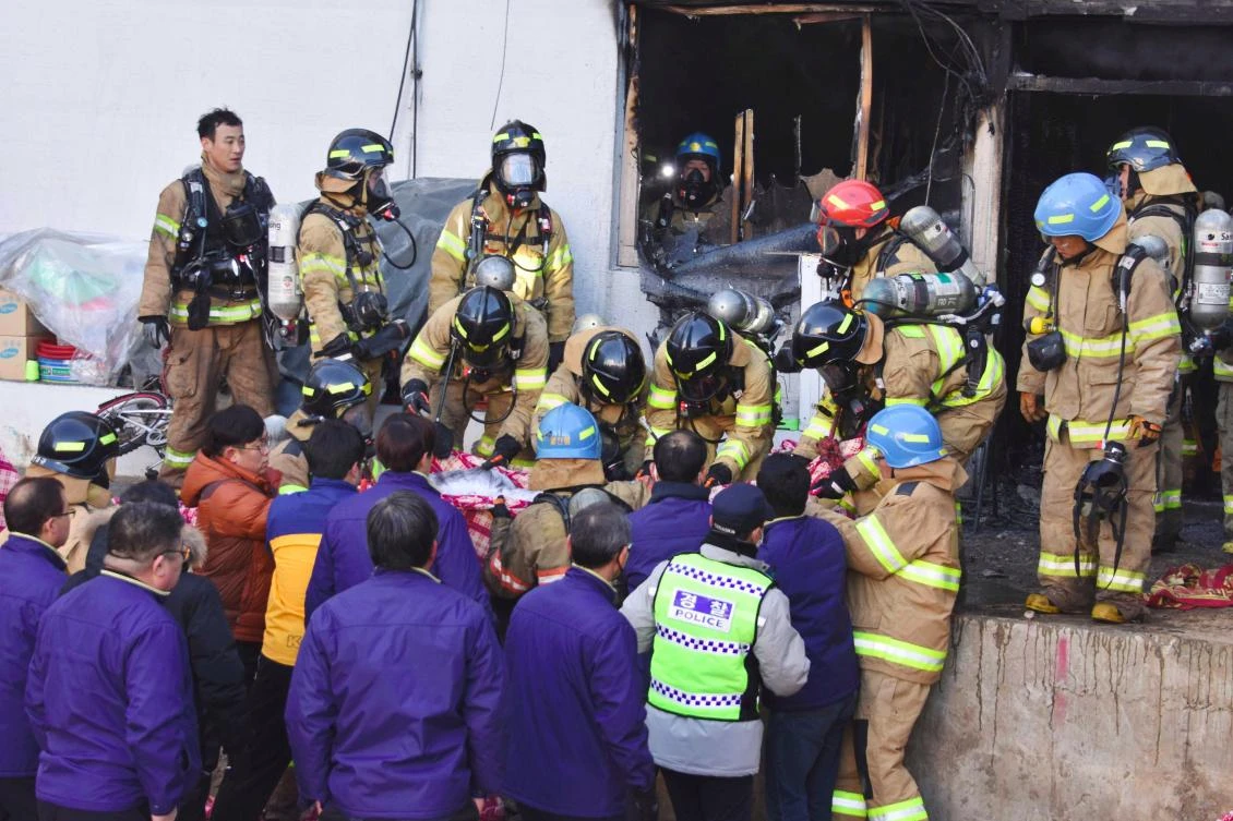 South Korean rescue workers remove the bodies of victims after a fire at a hospital building in Miryang. (Yonhap via AFP)