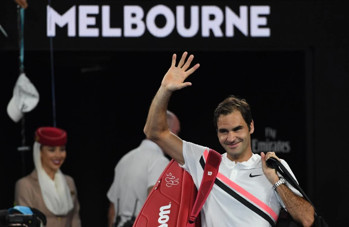 Switzerland’s Roger Federer waves after South Korea’s Chung Hyeon retired from their men’s singles semifinals match of the Australian Open tennis tournament. (AFP)