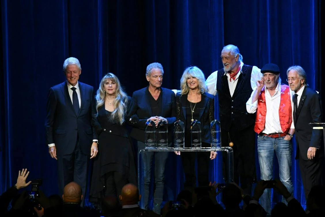 (From L-R) Former US president Bill Clinton, Stevie Nicks, Lindsey Buckingham, Christine McVie, Mick Fleetwood, John McVie and Recording Academy president Neil Partnow pose on stage at the 2018 MusiCares Person Of The Year gala at Radio City Music Hall in New York on January 26, 2018. (AFP)