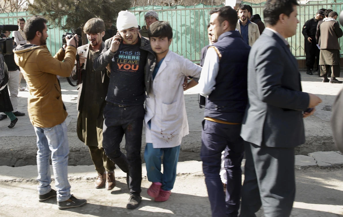 A wounded man is assisted at the site of an explosion in downtown Kabul, Afghanistan, Saturday, Jan. 27, 2018. (AP)