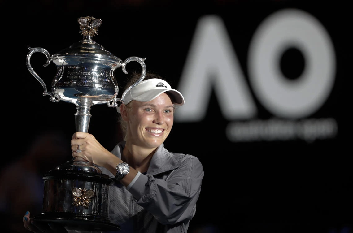 Denmark's Caroline Wozniacki holds her trophy aloft after defeating Romania's Simona Halep in the women's singles final at the Australian Open. (AP)