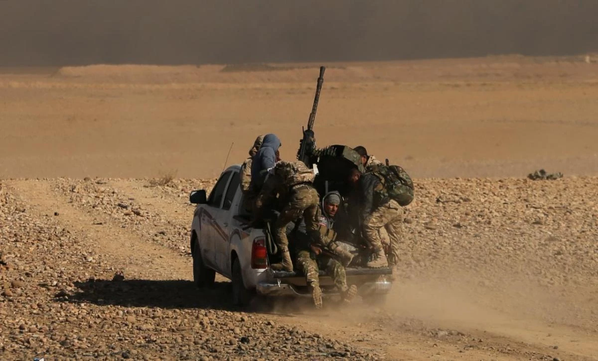 Iraqi forces backed by tribal militias during a battle to retake a village from Daesh on the eastern bank of the river Tigris. A US airstrike killed eight Iraqi security personnel on Saturday. (Reuters)