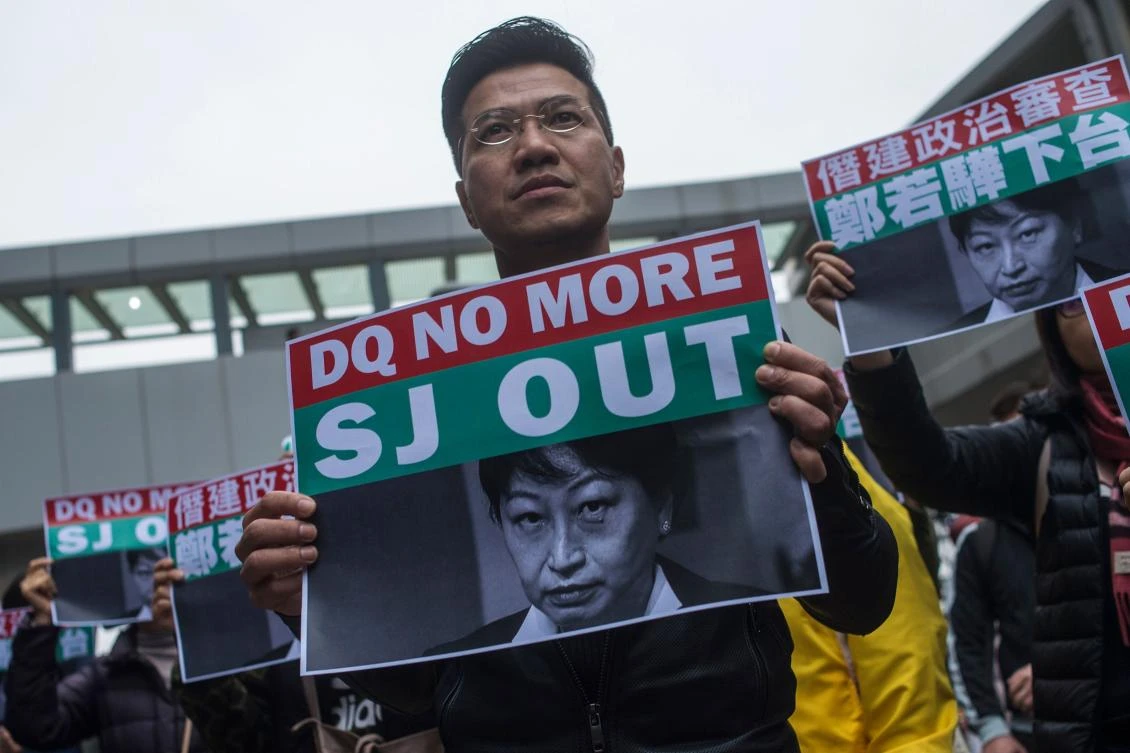 Former pan-democracy lawmaker Gary Fan holds a poster of Secretary for Justice Teresa Cheng during a protest in Hong Kong on Januray 28, 2018. (AFP)