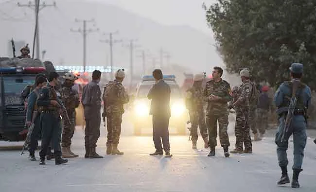 Afghan security personnel gather as they keep watch near the site of a suicide bomb attack near the Marshal Fahim military academy base in Kabul. (AFP)