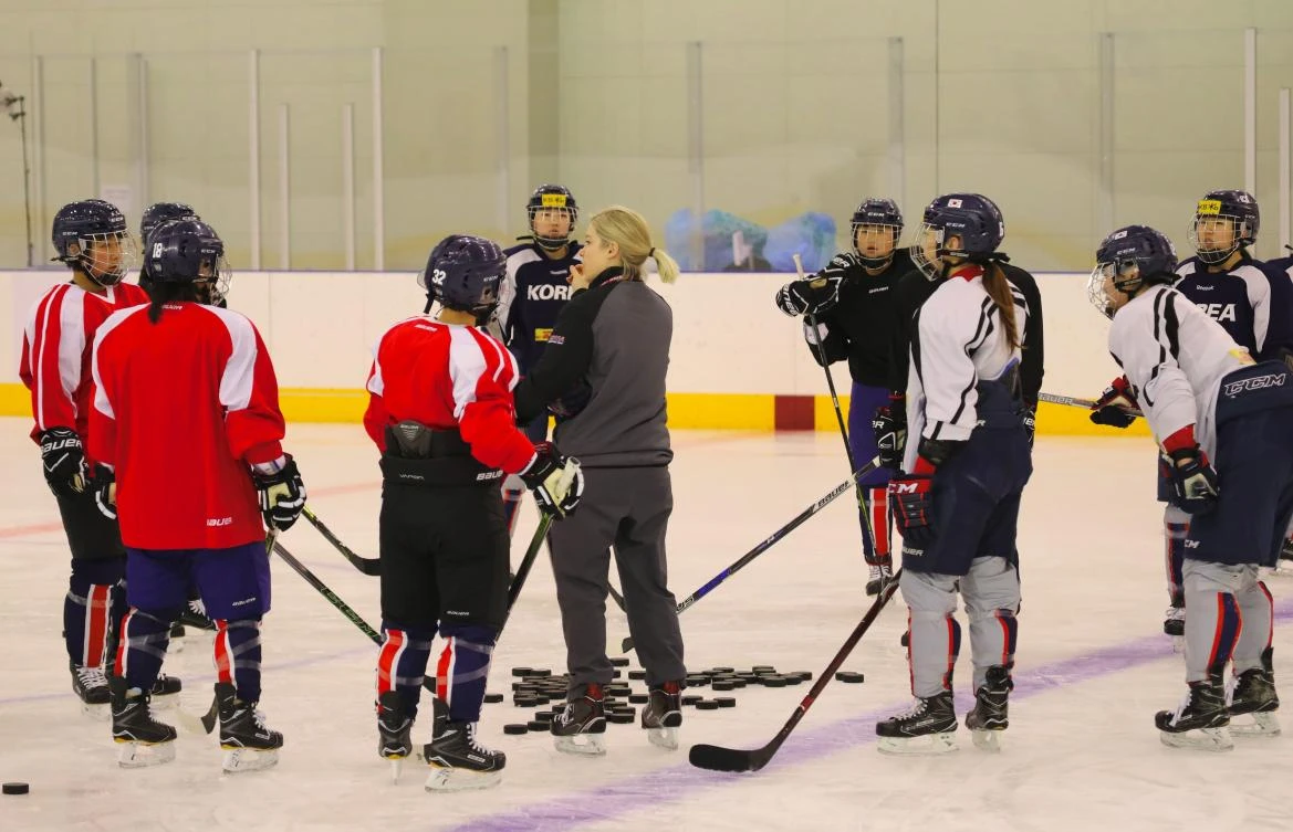 North Korean female ice hockey players, in red, train with their South Korean teammates at the national training center in Jincheon on Sunday, January 28. (Korean Sport and Olympic Committee via AFP)