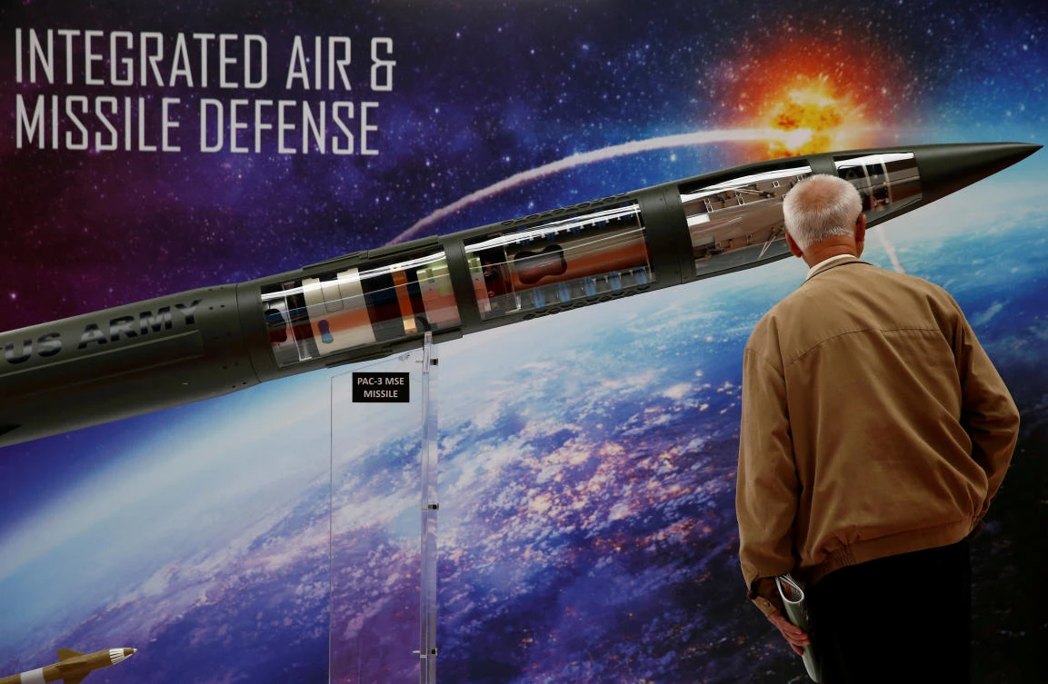 A man looks at a Patriot Advanced Capability (PAC-3) Missile model by Lockheed Martin at an international military fair. Lockheed, like its peers in the US, is expected to gain from an increase in defense spending under President Donald Trump’s administration. (Reuters)