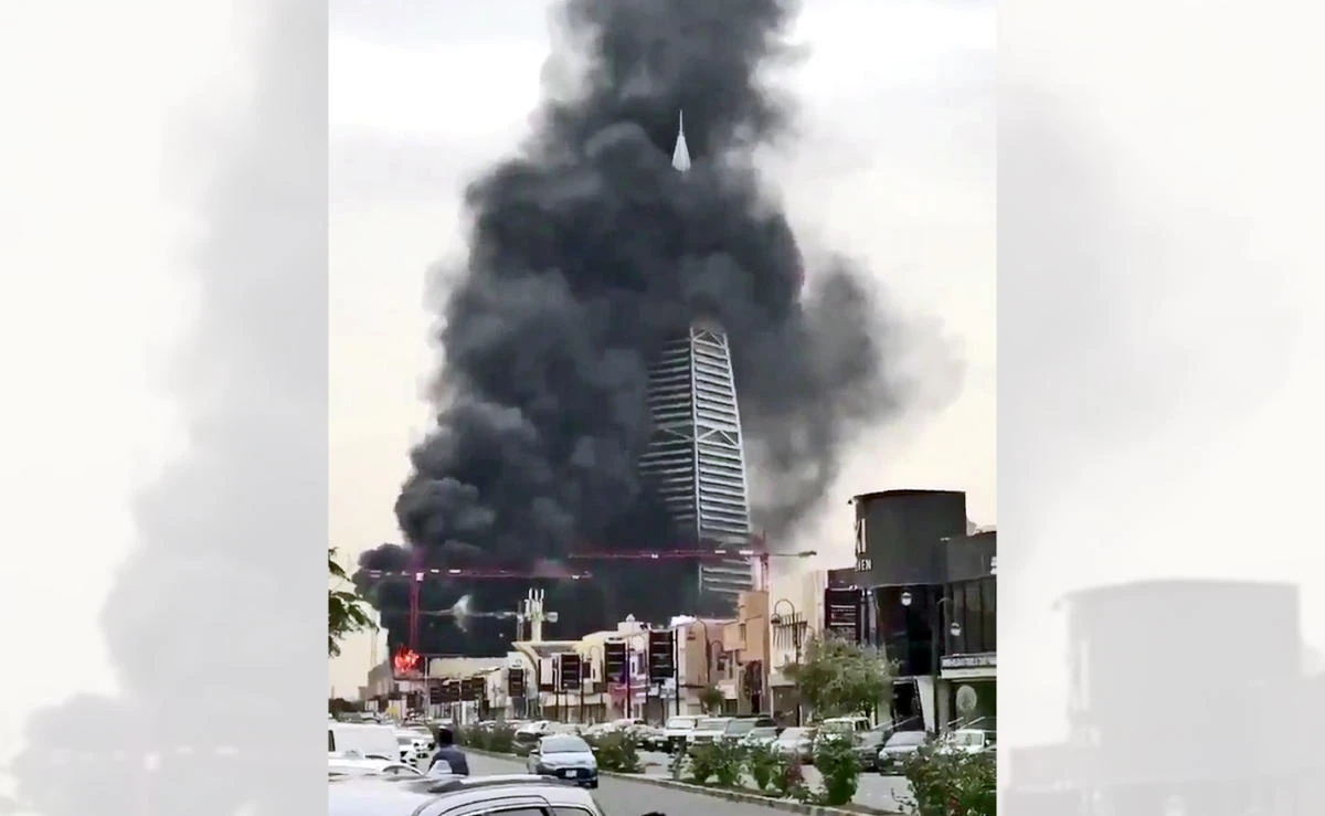 Smoke rises from a building site in Riyadh, shrouding nearby Al-Faisaliah tower